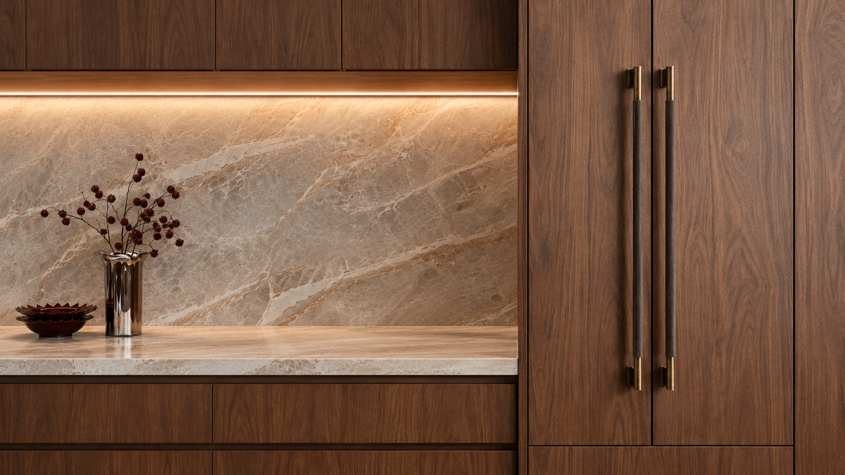 PEDRO knurled brass long pulls on walnut cabinetry beside a stone backsplash
