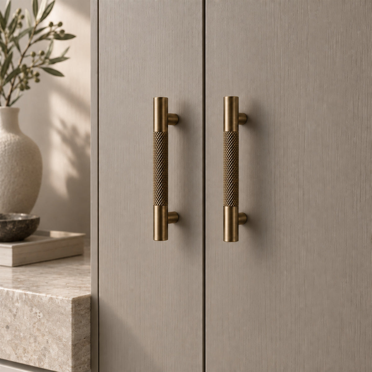 TRACE Knurled Cabinet Pull in Antique Brass — shown on cabinetry